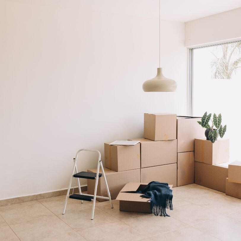 end of tenancy cleaning with cardboard boxes in the corner of a room